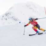 A ski racers tackles a gate in the Peak to Valley Race, the longest giant slalom race in the world, which happens on Whistler Mountain.