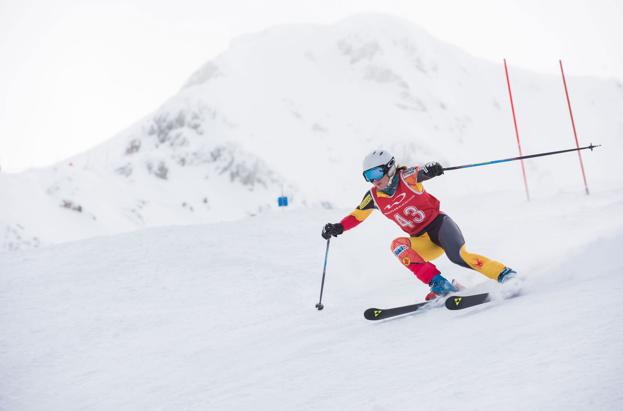 A ski racers tackles a gate in the Peak to Valley Race, the longest giant slalom race in the world, which happens on Whistler Mountain.