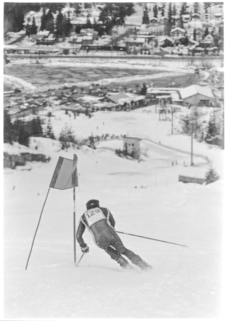 A ski racer heads down the mountain with views of Creekside in the distance (1991).