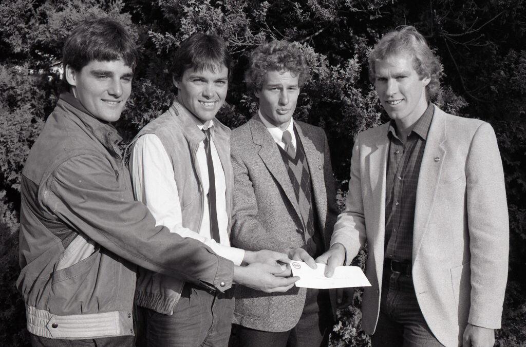 This photo is from 1984. Dave Murray, then director of skiing for Whistler Mountain, presents a cheque to (l-r) national team members Felix Belzyck, Chris Kent and Gary Athans. 