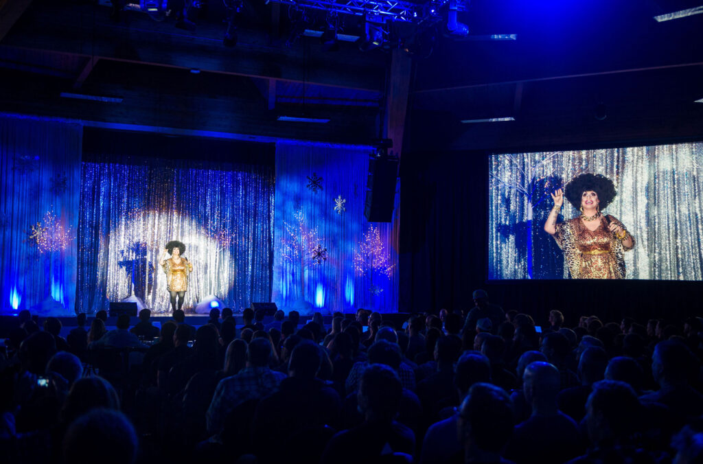 A drag queen in a sparkly outfit is centre stage at the Whistler Pride and Ski Festival.