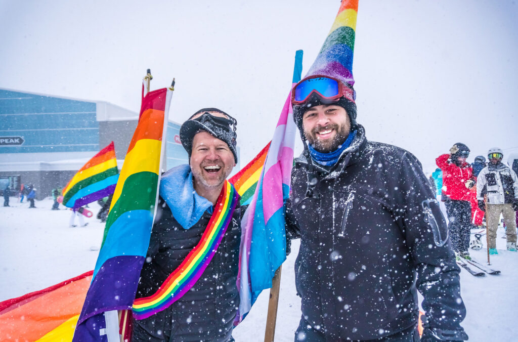 Past Whistler Pride festival organizer, Dean Nelson holds a rainbow flag on Whistler Mountain.