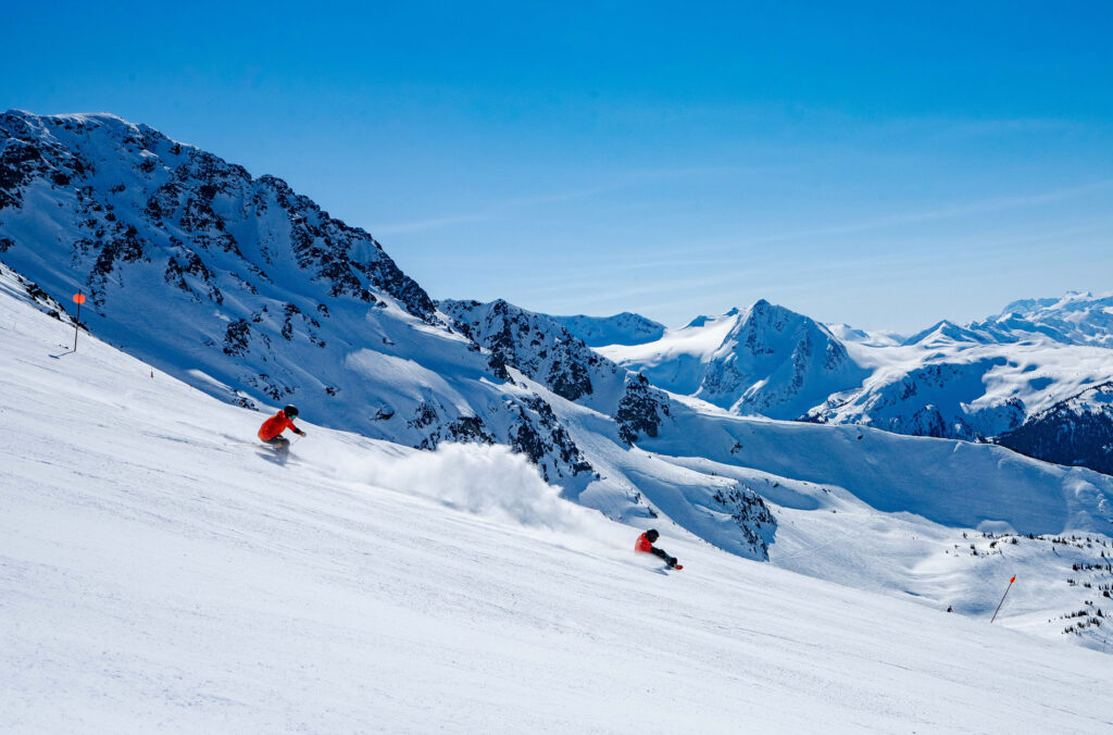 A sit skier and their coach carve the corduroy on Whistler Blackcomb.