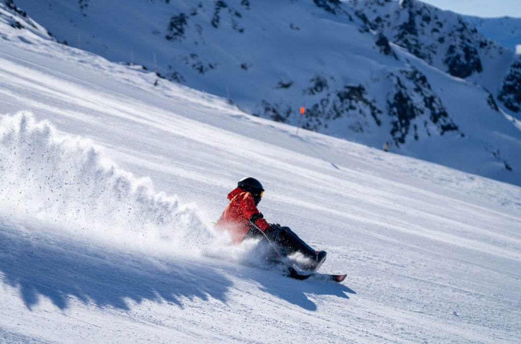 A sit skier carves the corduroy on Whistler Blackcomb.