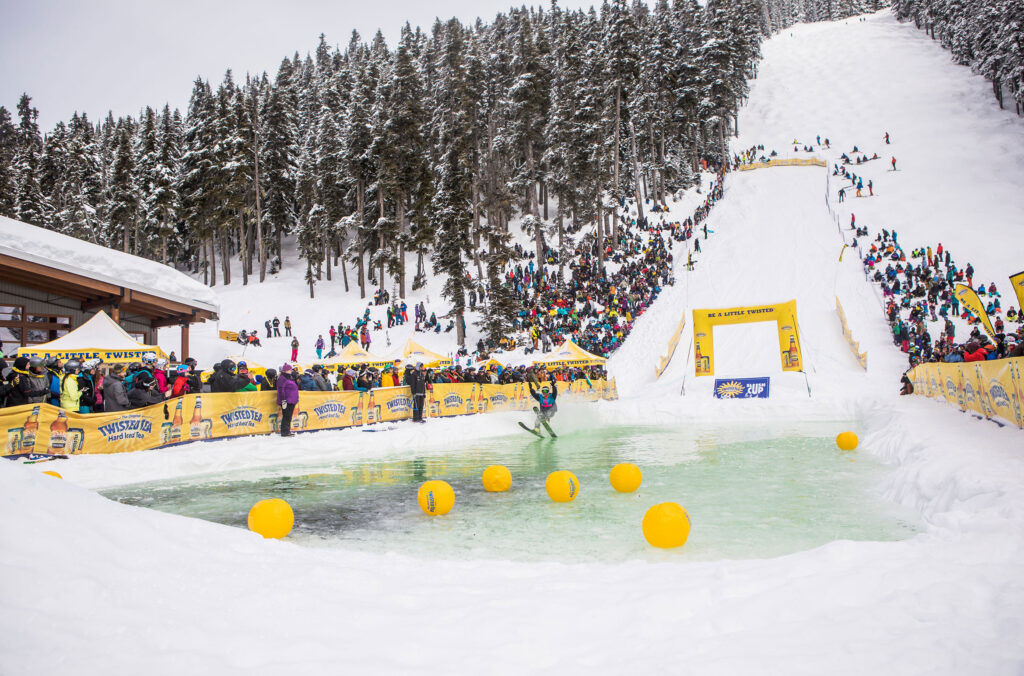 A skier sees how far they make it pver the icy waters of the Slush Cup, part of the Whistler Ski and Snowboard Festival. 