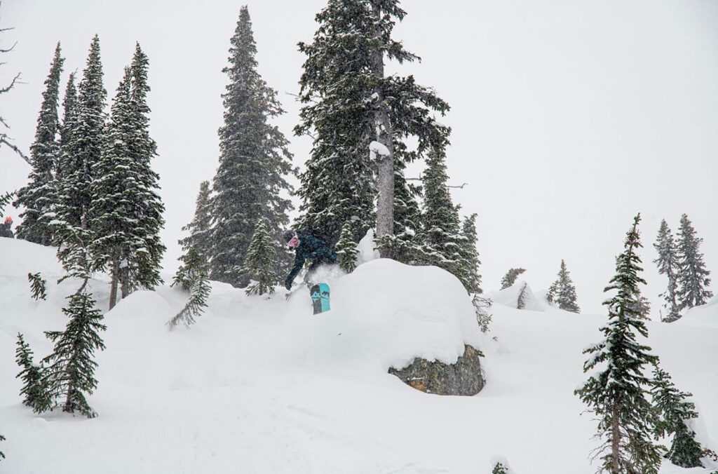 Snowboarder Sandy Ward getting air in Whistler's backcountry.