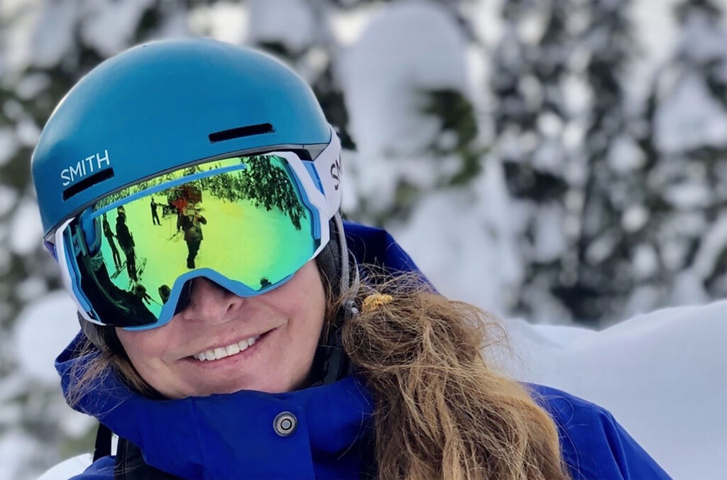 Jill Dunnigan looking directly at the camera with her ski helmet and goggles on.