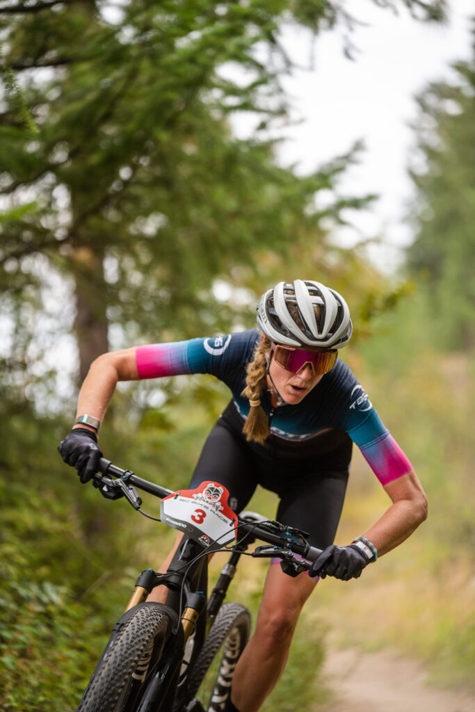 A picture of Chloe Cross competing in a bike race.