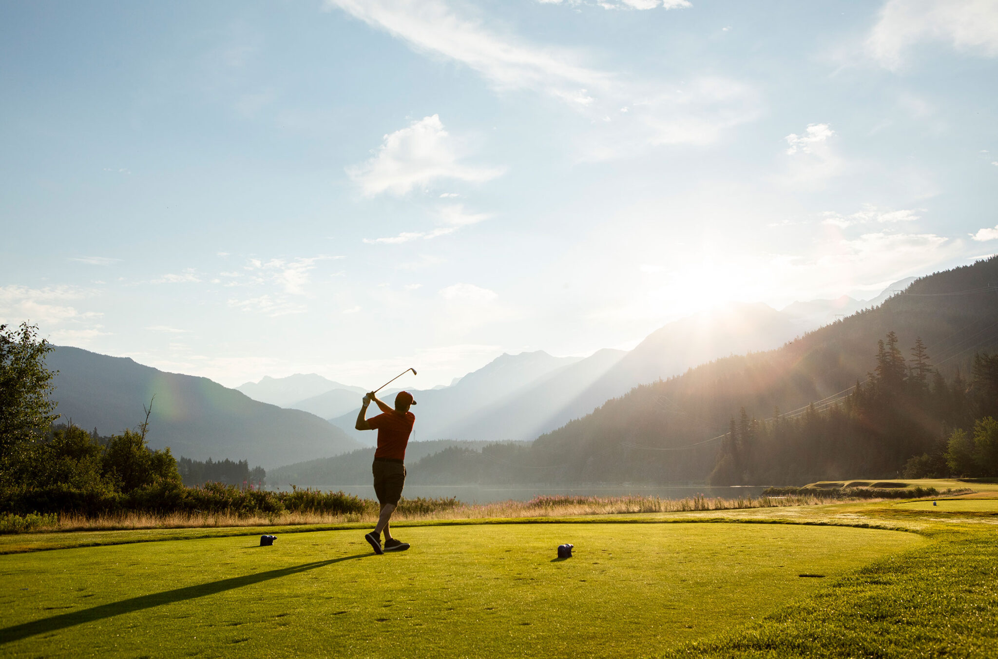 A golfer enjoys views of the lakes and mountains in Whistler.