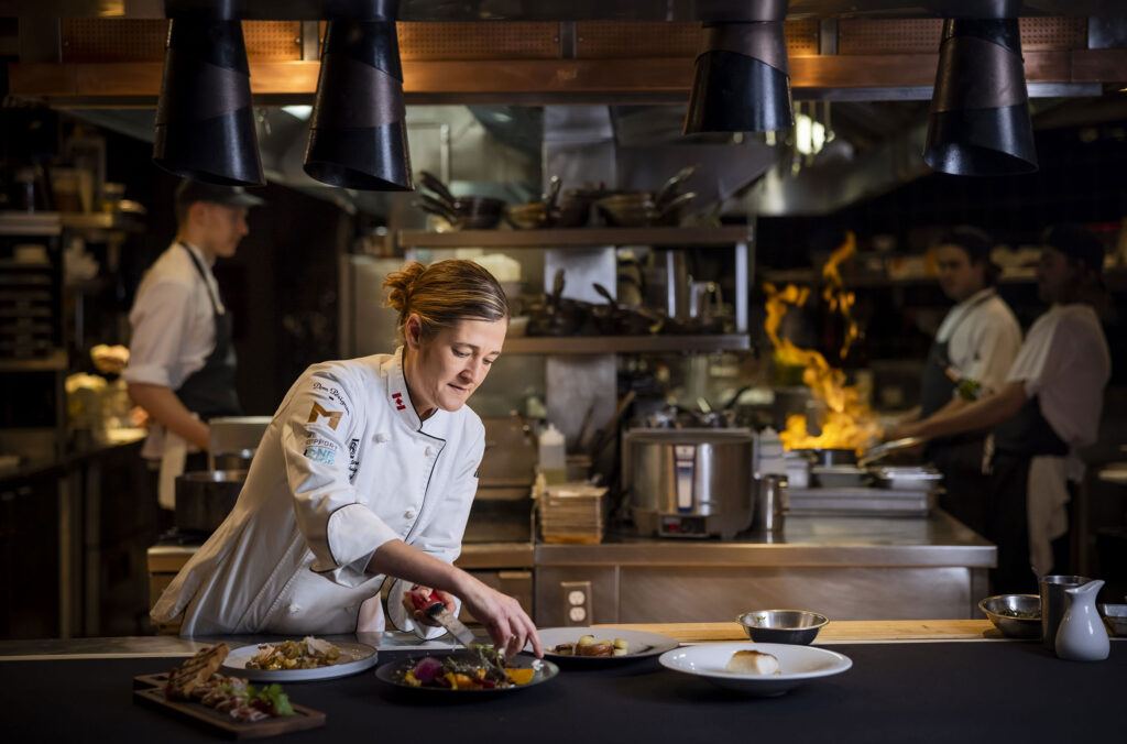 Executive Chef Melissa Craig plates up several dishes at the Bearfoot.