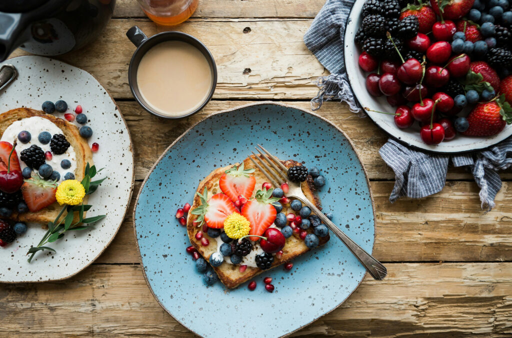 A colourful array of healthy breakfast foods on a wooden table.