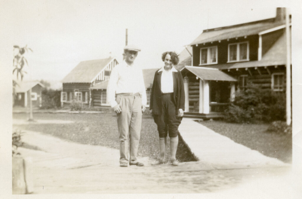 Black and white photo of Alex and Myrtle Philip standing outside Rainbow Lodge in the 1930s.