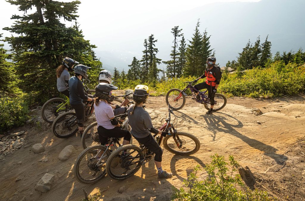 A group of mountain bikers take a lesson at Whistler Mountain Bike Park.