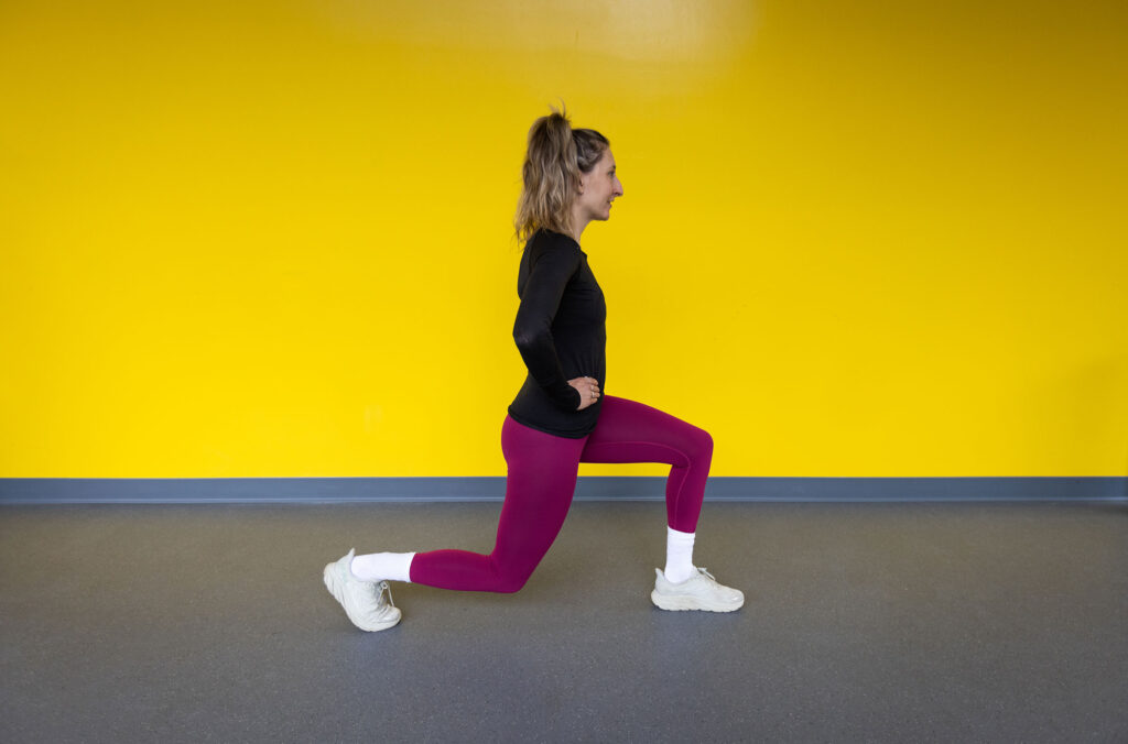 Pro biker, Hailey Elise, performs a backward lunge, a great exercise for getting ready to bike season.