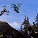 Two bikers spin skillfully in the air during Speed and Style at Crankworx Whistler.