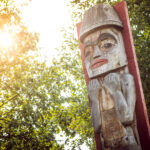 A photo of the Welcome Pole at the front entrance of the Squamish Lil'wat Cultural Centre in Whistler.