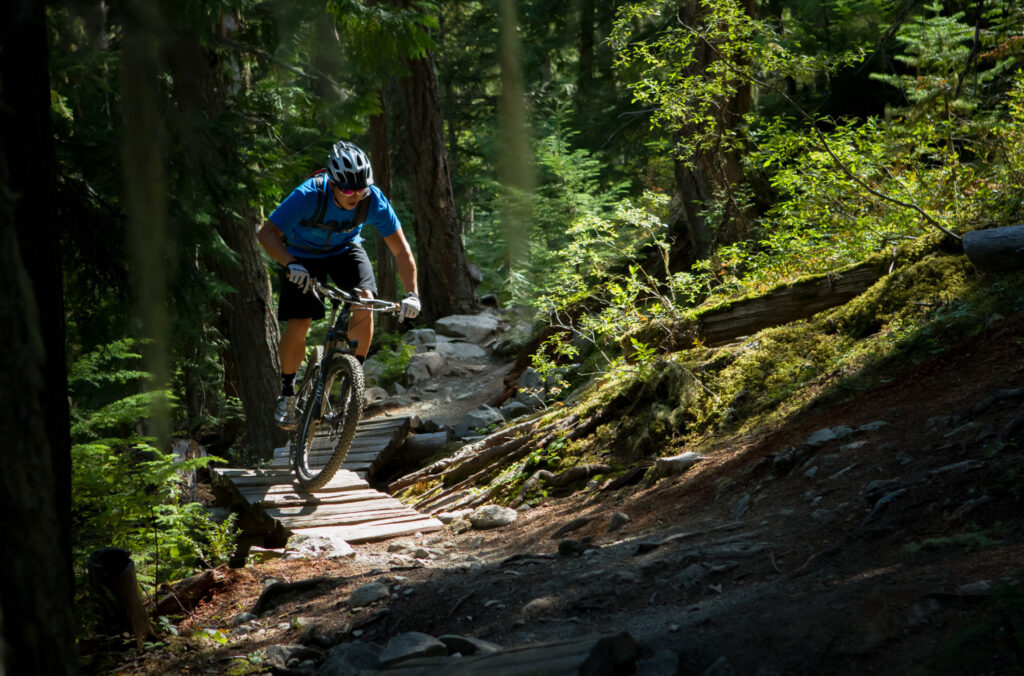 A mountain biker hits the woodwork on one of the Lost Lake trails in Whistler.