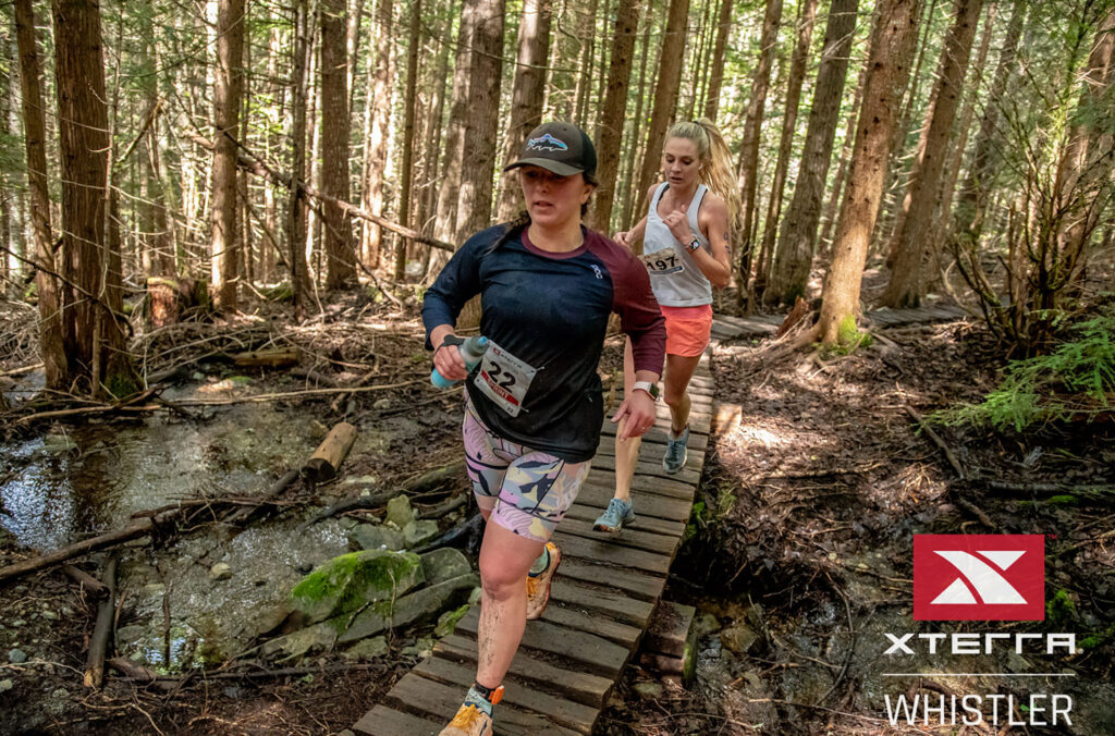 Two runners tread carefully as they run over woodwork on the XTRERRA Whistler's run course.