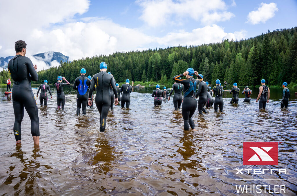 Swimmers wade into the waters of Lost Lake for the start of the Whistler XTERRA.