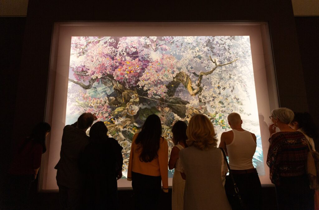 People admiring Rebirth by Manabu Ikeda