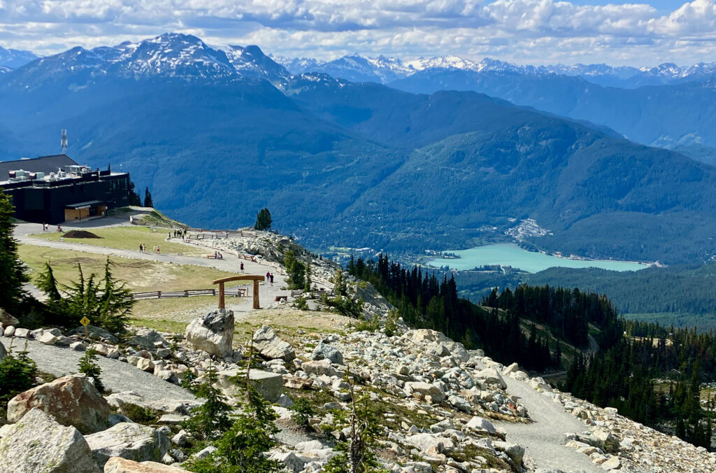 A view of the Rendezvous Lodge on Blackcomb Mountain, with the stunning Green Lake in the background down in the valley.