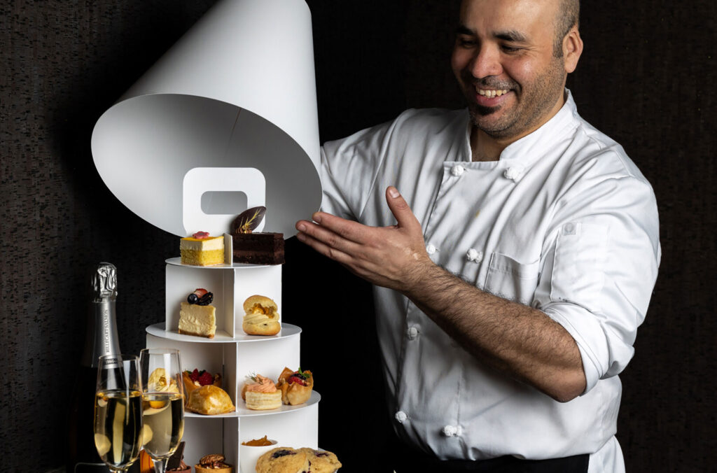 A chef at the Four Seasons Whistler Resort presents a delicious-looking tower of High Tea options.