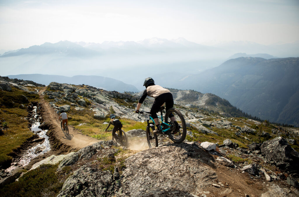 Three riders head off down the trail after being dropped off by the helicopter.