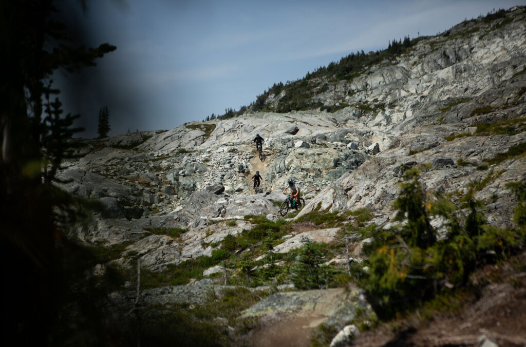 Three riders weave their way down the heli biking trail.