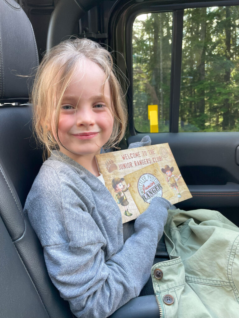 Ella holds up her ranger worksheet after the bear viewing tour with Whistler Photo Safaris.