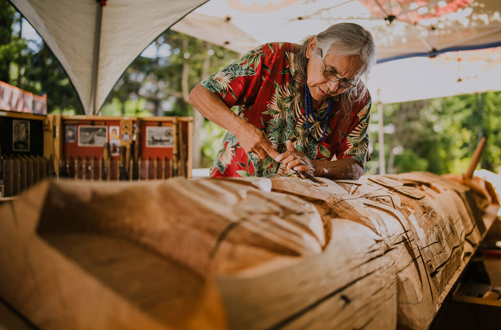 Master Carver Xwalacktun works on a post that will go outside the SLCC.