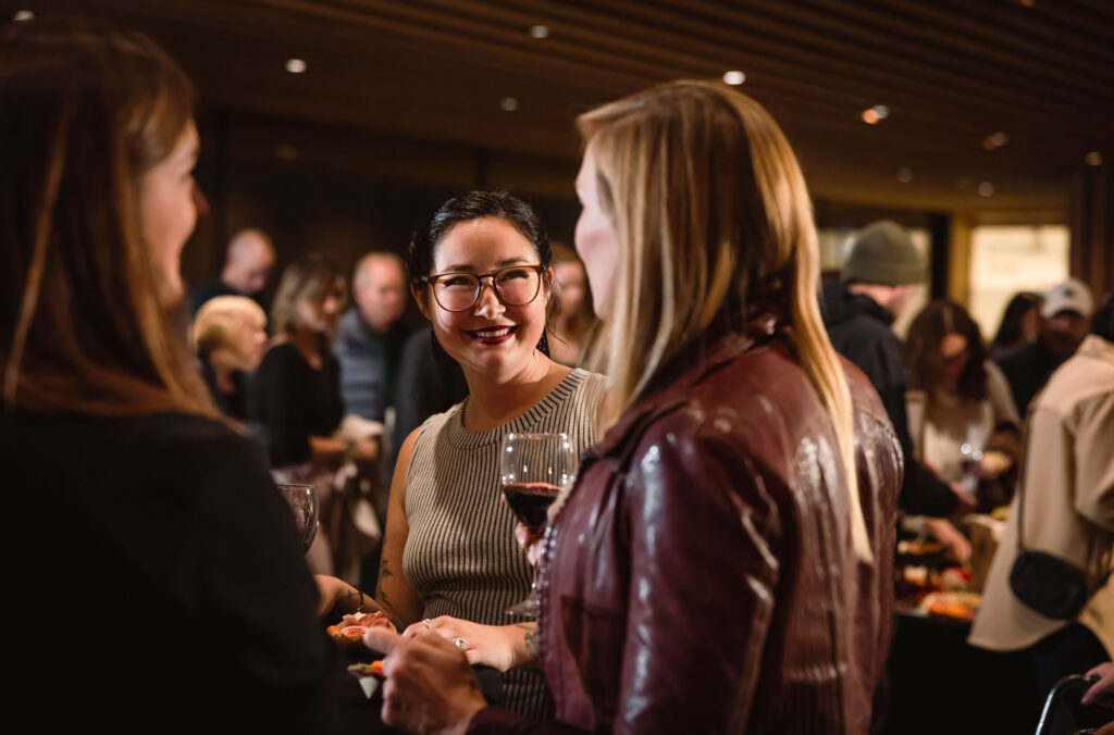 A group of friends drink wine at the Audain Art Museum while on the Whistler Wine Walk. 