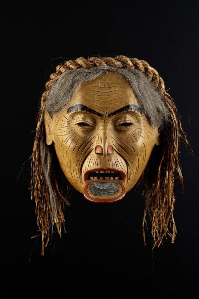 An Indigenous carving of an old woman.