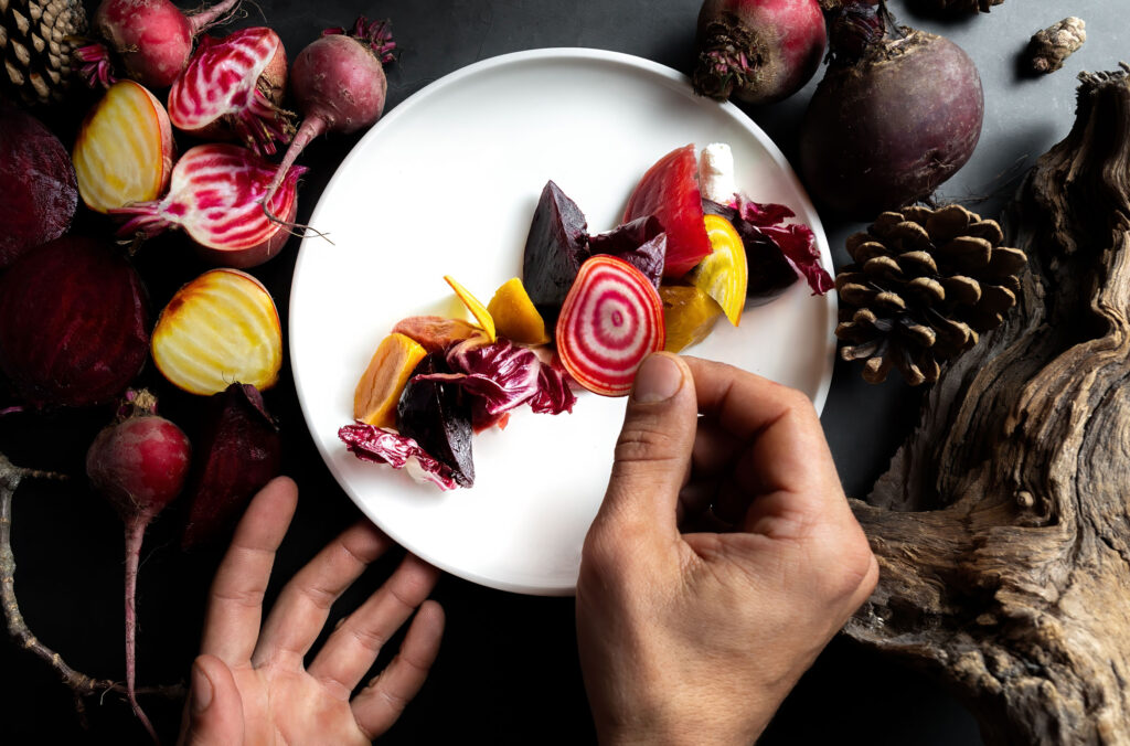 A chef adds the finishing touches to a beautiful plate of fall-coloured food during Whistler Cornucopia.