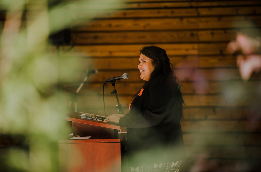 Georgina stands at the lectern speaking to a crowd who have come to the SLCC for National Truth and Reconciliation Day.