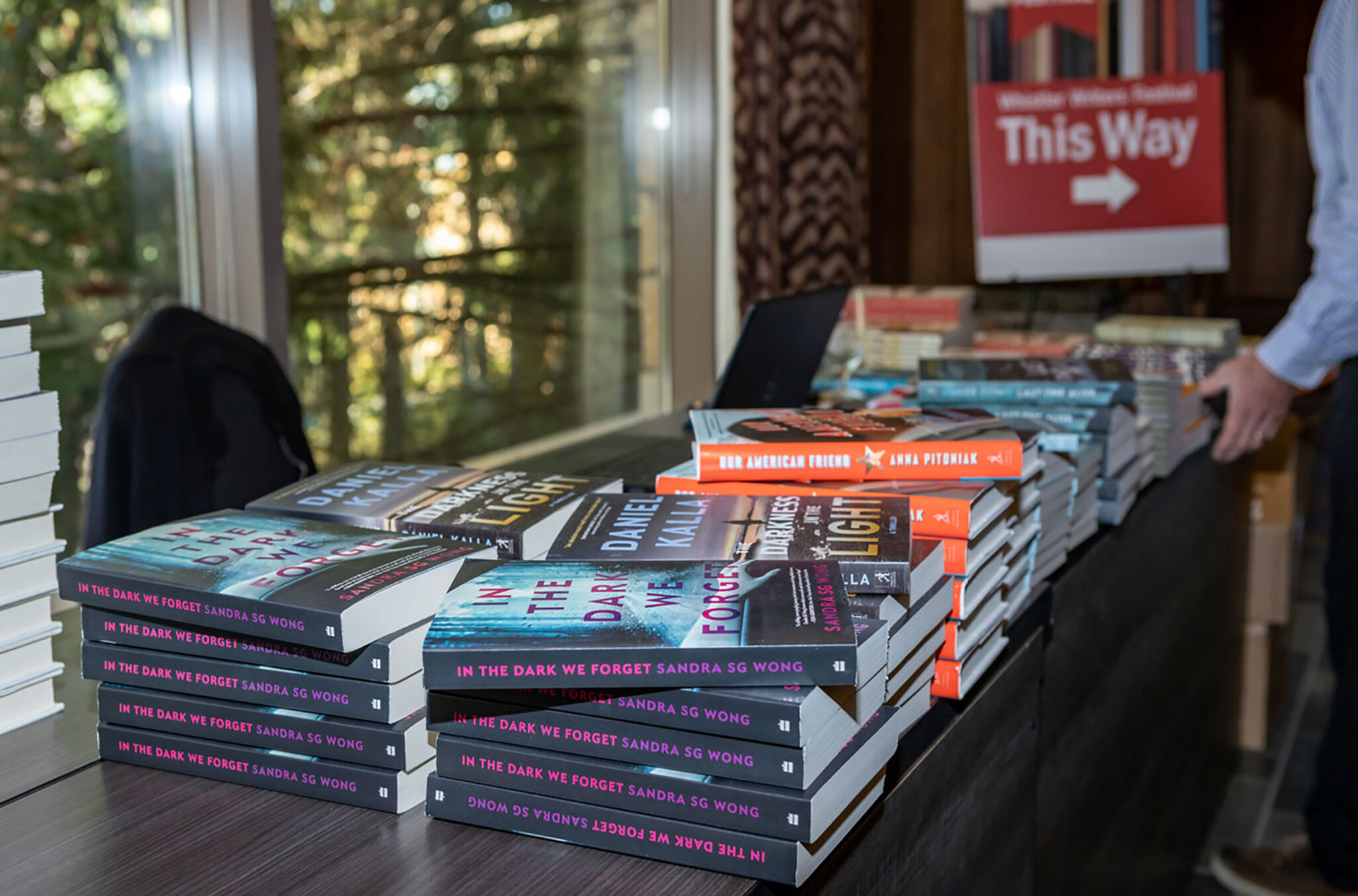 A table stacked with books sits outside the Whistler Writers Festival event room at Fairmont Chateau Whistler.