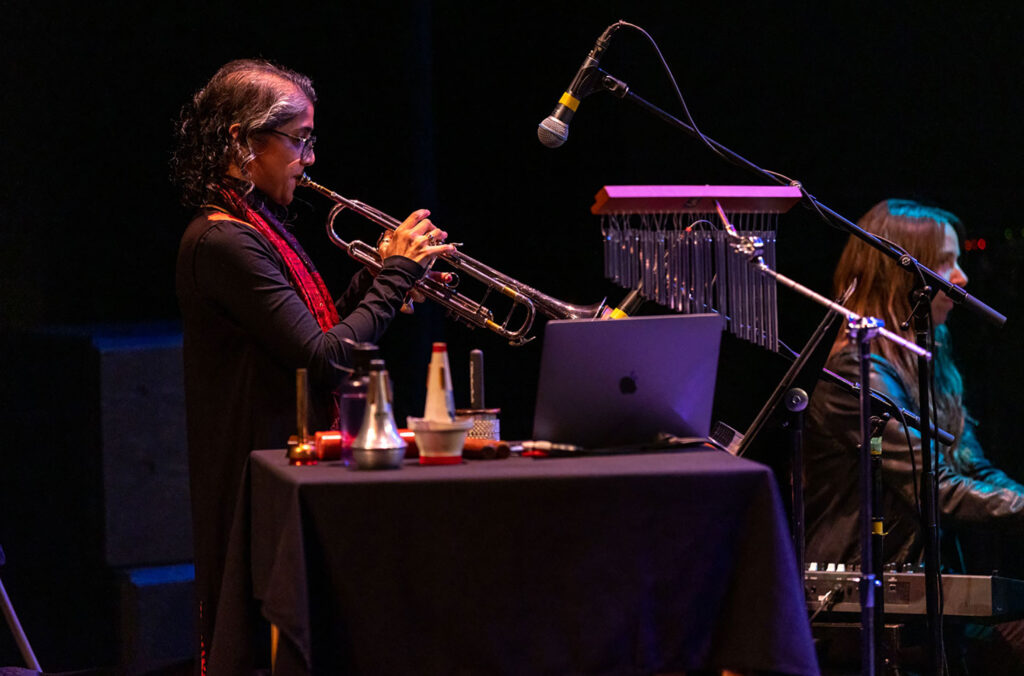 A woman plays the trumpet on stage at the Whistler Writers Festival cabaret event.