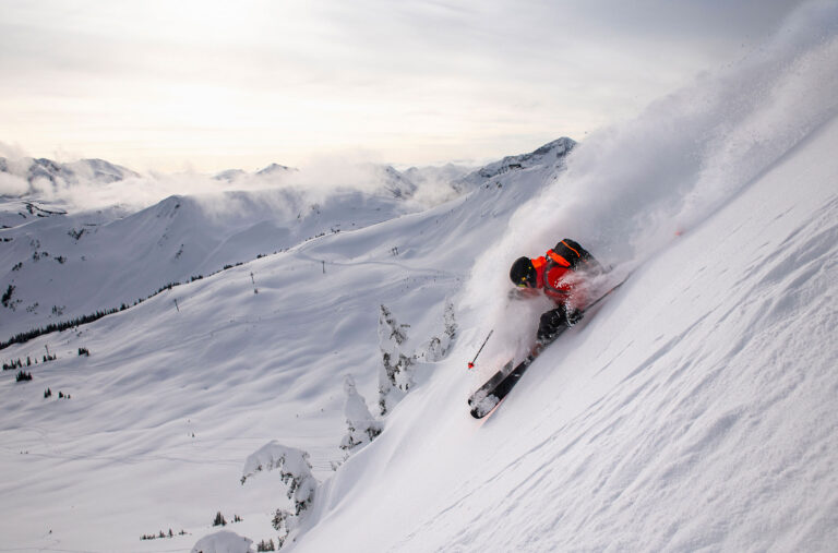 A skier makes their way down a snowy slope on Whistler Blackcomb.
