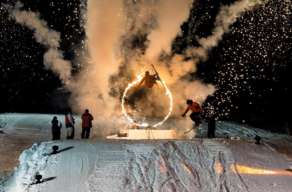 Ski and snowboard athletes fly through rings of fire in the Fire & Ice Show in Whistler.