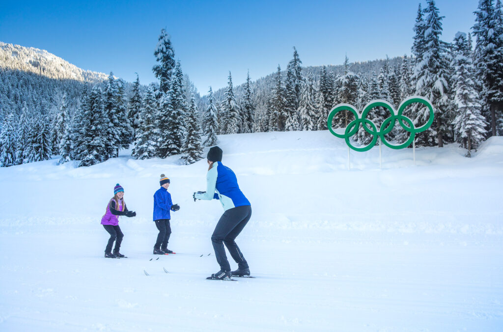 Two kids get a cross-country ski lesson at Whistler Olympic Park.