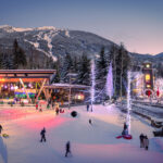 A shot of Whistler's Olympic Plaza in the purple hues of alpen glow in the winter.