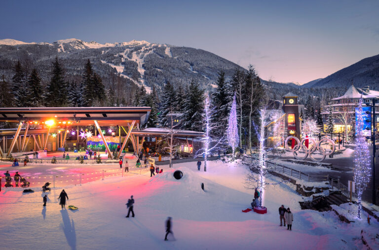 A shot of Whistler's Olympic Plaza in the purple hues of alpen glow in the winter.