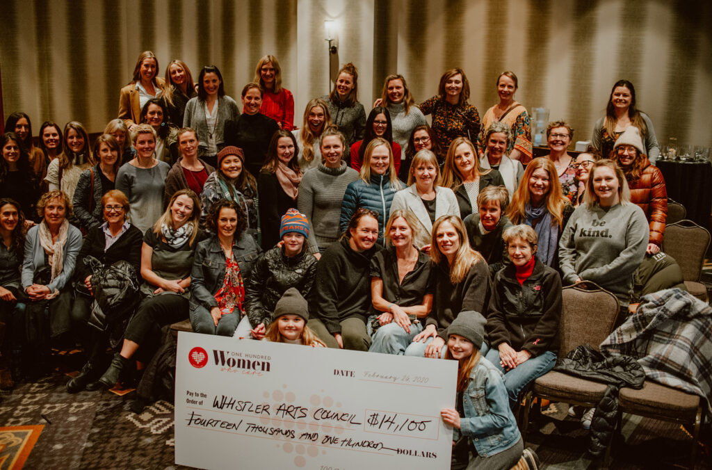 A group shot of the members of 100 Women Who Care Whistler with a cheque for Whistler Arts Council. 