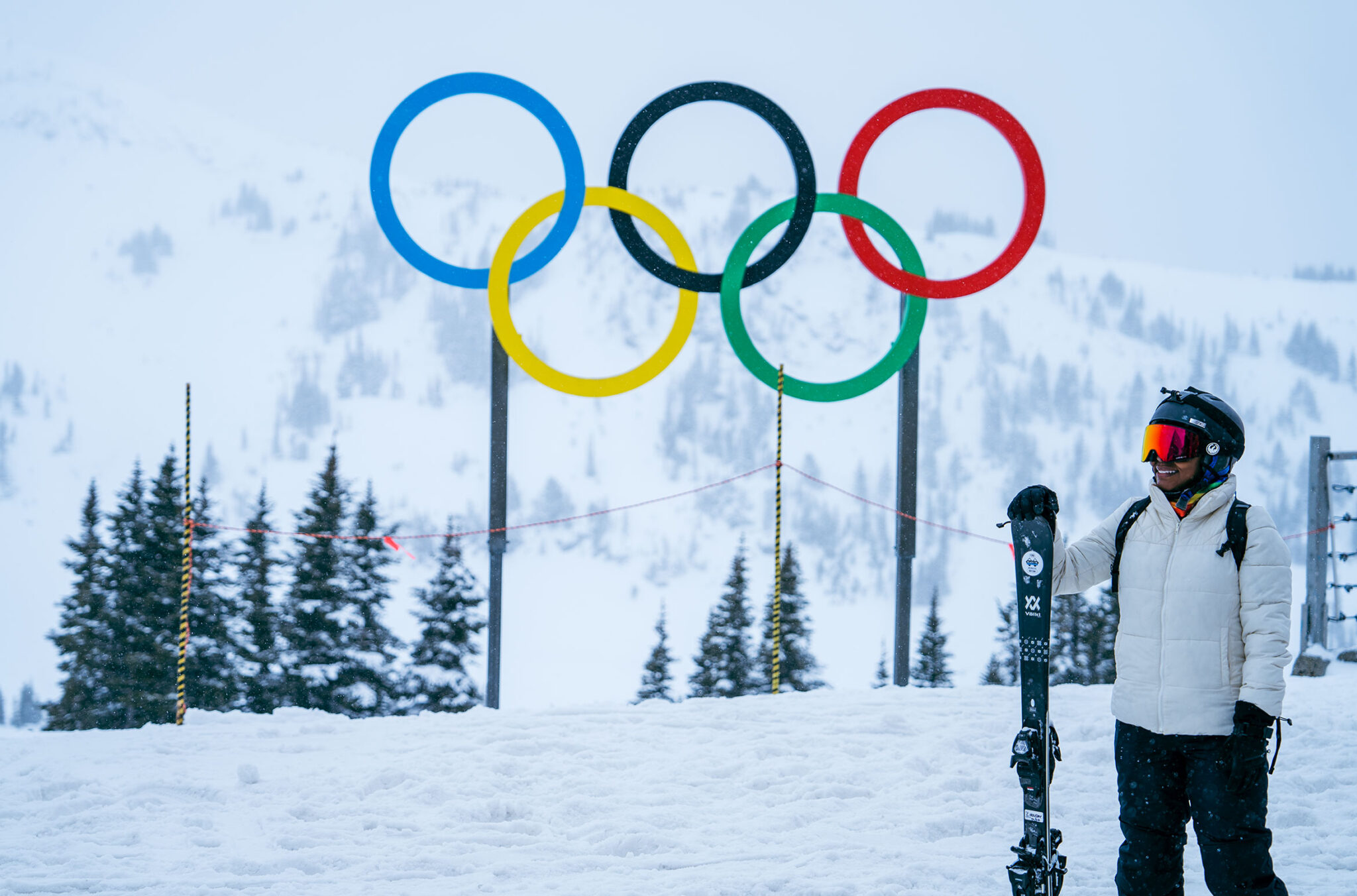A skier stands by the Olympic rings at the top of Whistler Mountain in Whistler.