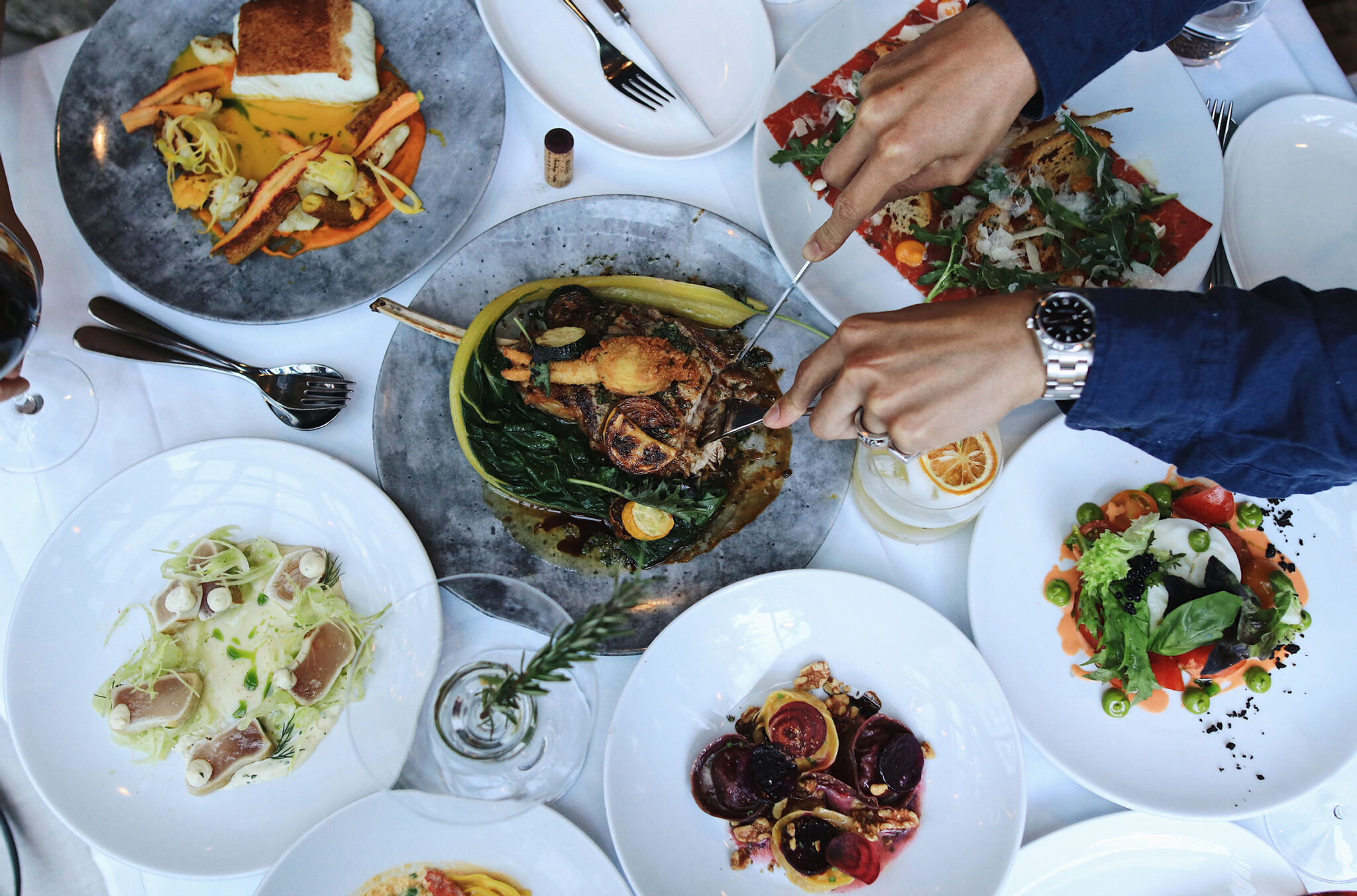 A table of delicious food shot from above at the Il Caminetto in Whistler.