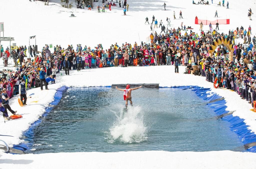 A skier tries to ski across a pool of water at the Slush Cup, part of the World Ski and Snowboard Festival in Whistler.