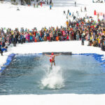 A skier tries to ski across a pool of water at the Slush Cup, part of the World Ski and Snowboard Festival in Whistler.