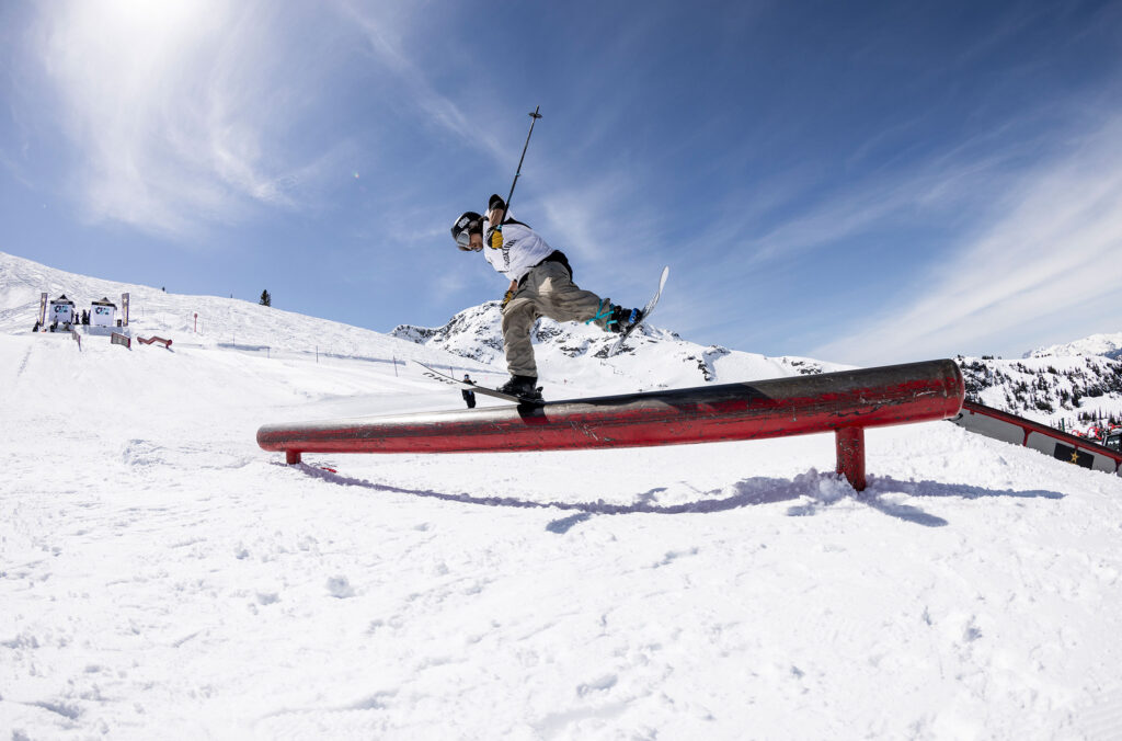 A skier does a trick along a feature in the spring sunshine during an event at the World Ski & Snowboard Festival in Whistler.