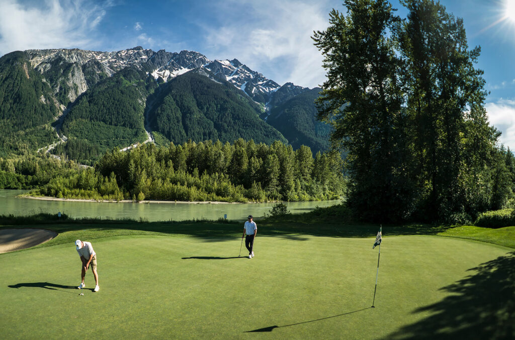 Two golfers enjoy the Big Sky Golf Course in Pemberton, just north of Whistler.