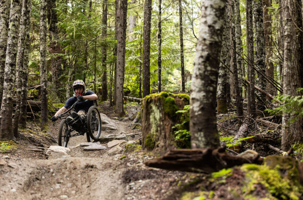 Athlete, Jayden Glentworth tackling the trails on his adaptive mountain bike in the Whistler Mountain Bike Park.