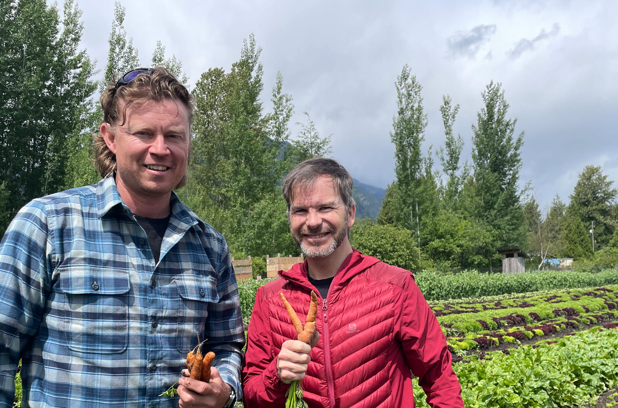 Eric Griffith from Alta Bistro and Mike Douglas stand in the lush fields of Root Down Farm in Pemberton.